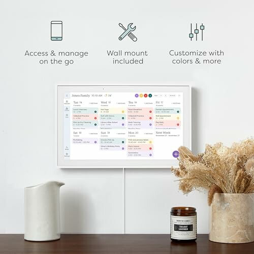 Wall-mounted digital calendar with remote access, customization options, and decor items.